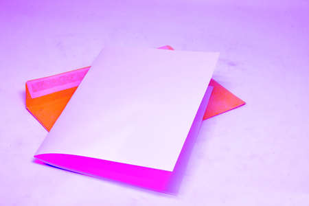 Blank white paper on a paper envelope. Top view of a paper envelope. minimalist style. Changed color schemeの写真素材
