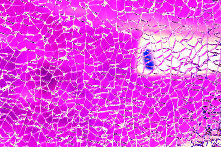 Broken tempered glass. Glass web of cracks. Changed color scheme. colorful background