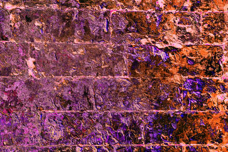 Old brickwork covered with peeling plaster, brick and cement at the joints between the bricks. Changed color scheme. colorful abstract backgroundの写真素材
