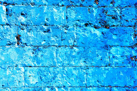 Old brickwork covered with peeling plaster, brick and cement at the joints between the bricks....