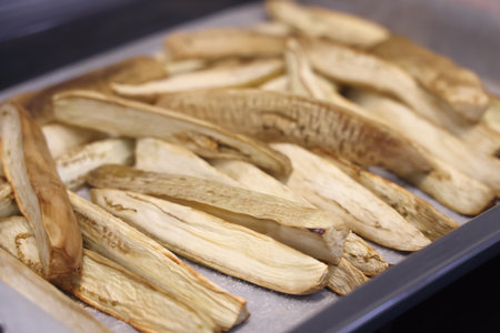 Fresh eggplant fruit slices isolated on white backgroundの写真素材