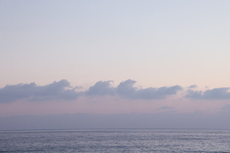 Sea and clouds on the horizon, evening lighting, minimalism