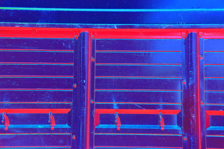Close-up of the metal side of a large truck. Changed color scheme