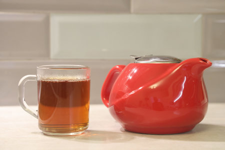 A glass of tea and a tea pot. Morning teaの写真素材