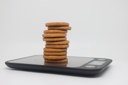 A pack of cookies on an electronic kitchen scale, accurate calorie counting, proper nutrition, dietの写真素材