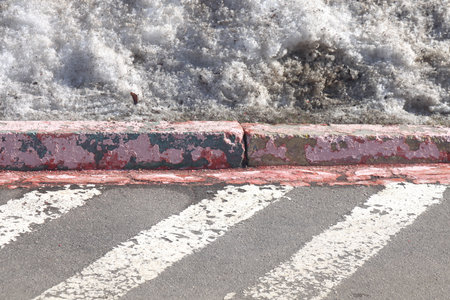Pink peeling car park border, road markings and gray spring snow, minimalism, gray backgroundの写真素材