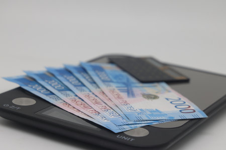 Electronic kitchen scales with euro banknotes and calculator, accounting and control of family expensesの写真素材