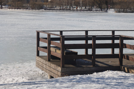 Landscapes in the park with melting snow, puddles and ice in spring. Residential and spring buildings landscapes of Butovo, Moscow, thawed patches, March 2023の写真素材