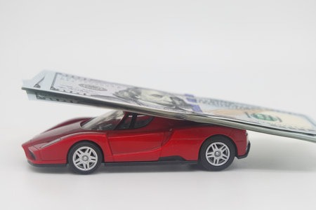 On the car is a wad of dollars, buying a car, auto insurance, cost of ownershipの写真素材