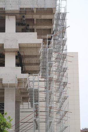 Scaffolding on multi storey building facade during facade renovation. bright sunny dayの写真素材