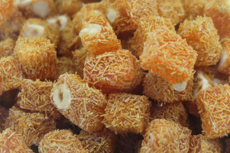 Traditional oriental sweet pastry cookies, nuts, dried fruits, pastilles, marmalade, Turkish desert with sugar, honey and pistachio, in display at a street food marketの写真素材