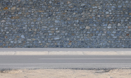 Road curb and highway on the background of a stone wall, minimalismの写真素材