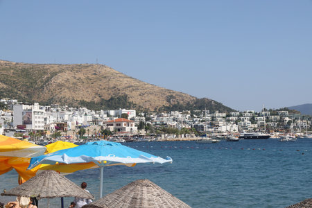 View of the city beach of Bodrum with beach umbrellas on the background of yachts, Marmaris, Turkey, May 2023の写真素材