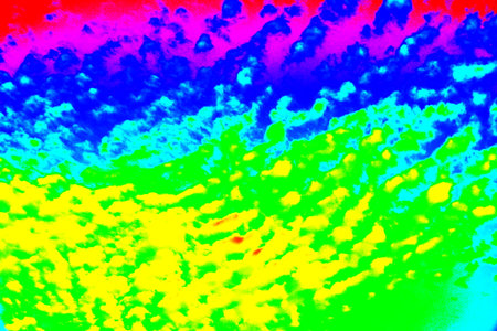Wavy clouds float across the blue sky. Colorful sky background. Changed color scheme