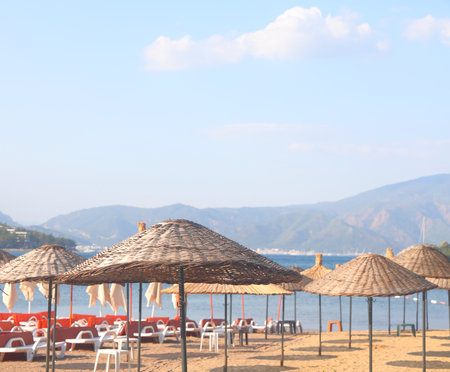 Straw umbrellas on the sandy beach in Marmaris, Turkiye, May 2023の写真素材