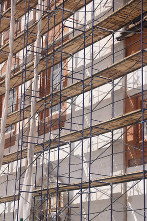 Workers on scaffolding at the construction site of a new buildingの写真素材