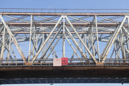 metal trusses of a bridge over a river, a bridge over a canal, a railway bridge