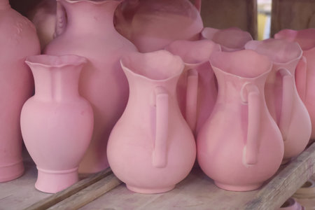 Pink unfired porcelain cup blanks coated with cobalt and prepared for firing, porcelain factoryの写真素材