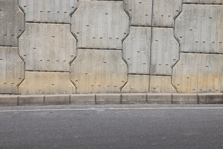 A section of an asphalt road with a curb stone.の写真素材