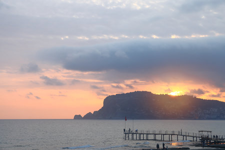 beach with sea and mountain at sunset, Alanya, Turkey, April, 2025の写真素材