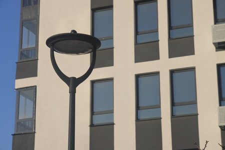 street lamp against the backdrop of the facade of a modern building, urbanismの写真素材