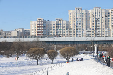 winter landscape park Yuzhnoye Butovo against the background of the ground metro line, Moscow, March 2024の写真素材