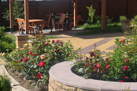 flowerbed and flowers on a summer cottage, roses and landscape designの写真素材