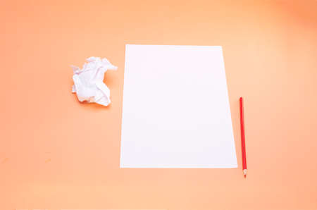 blank sheet of paper and red pencilの写真素材