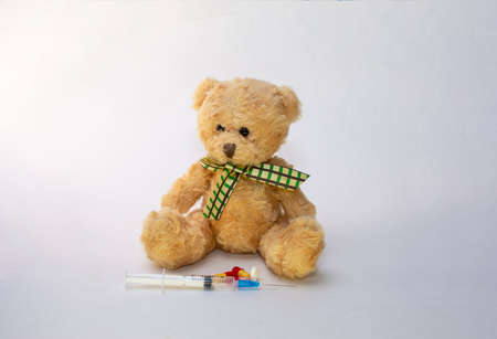 medical mask, pills syringe, bear
