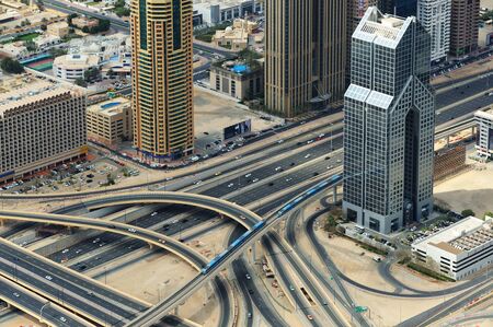 Two trains road junction and skyscrapers from above in Dubai.のeditorial素材