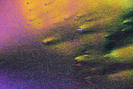 Colorful micro crystals in polarized light. Photo through a microscope.