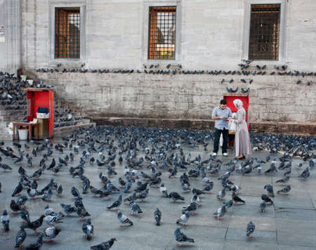 Yeni Cami in Eminonu neighborhood of Istanbul, Turkey. Square full of pigeons.のeditorial素材