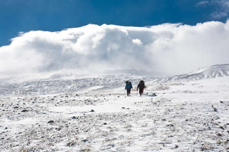 Hikers moving in snowy Kamchatka region, Russia の写真素材