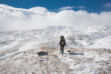 Hiker moving in snowy Kamchatka region, Russia.の写真素材