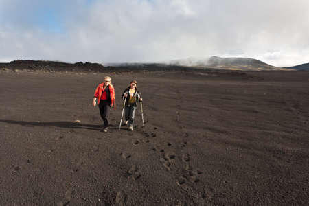 Hikers moving on volcano land in Kamchatka, Russia.の写真素材