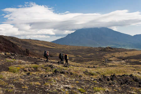Hikers moving on volcano land in Kamchatka, Russia.の写真素材