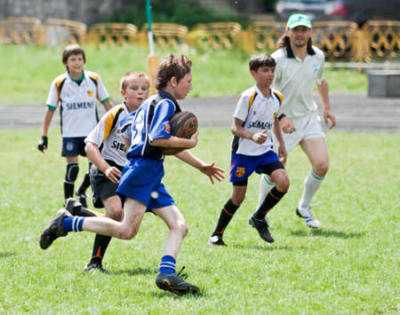 X RUGBY KIDS TOURNAMENT, UKRAINE, KIEV â MAY 19 : Mixed kid teams of mixed rugby players from all over the Ukraine in action at a X Kids Tournament on May 19, 2013 in Kiev, Ukraine.のeditorial素材