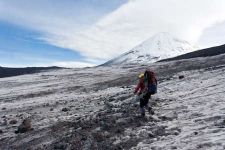 Hiker moving on volcano land in Kamchatka, Russia の写真素材