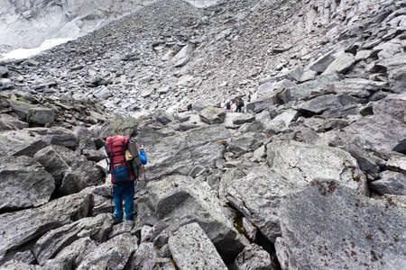 Group of hikers moving on wild meadows of Ural mountains, Russia.の写真素材