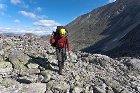 Hiker moving on wild meadows of Ural mountains, Russia.の写真素材