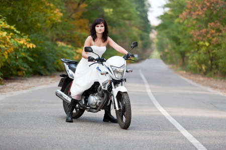 Bride in wedding dress on motorcycle.の写真素材