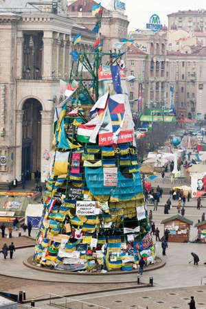 Kiev, Ukraine, January 20, 2014  People near the carcass of the Christmas tree with national flags and placards during a meetings on Maydan in Kiev のeditorial素材
