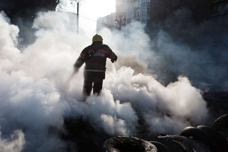 KIEV, UKRAINE - 23 JANUARY 2014: Firefighters extinguish a fire at the Independence square during Ukrainian revolution on January 23, 2014 in Kiev, Ukraine.のeditorial素材