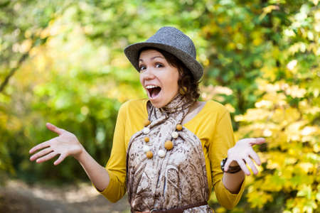 Cute cool girl having fun in autumn park.の写真素材