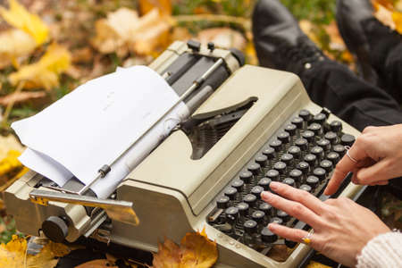 Typewriter outdoor with autumn leaves.の写真素材