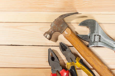 Set of tools over a wood panel with space for text.の写真素材