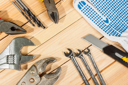 Set of tools over a wood panel with space for text.