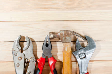 Set of tools over a wood panel with space for text.の写真素材