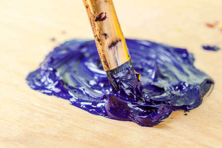 Macro view of oil pant on wooden background.の写真素材