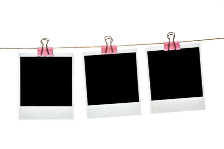 Black instant photo, hanging on the clothesline, isolated on white background.の写真素材